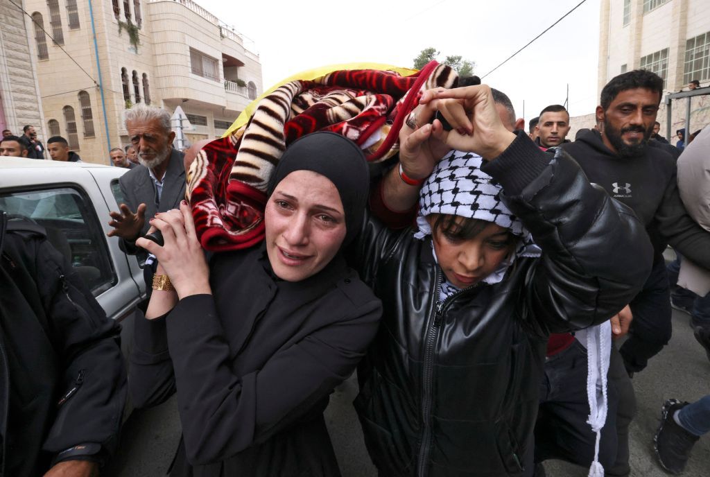 EDITORS NOTE: Graphic content / Friends and relatives of Palestinian Fulla al-Masalma, 16, mourn during her funeral in the village of Beit Awa, west of Hebron, in the occupied West Bank on November 15, 2022. - Israeli forces shot dead the Palestinian teenager in the occupied West Bank the previous day, the Palestinian health ministry said, while the army confirmed raids and a shooting incident in the area. The Israeli Defence Forces reported that its soldiers had fired at a car that was speeding toward them and that 