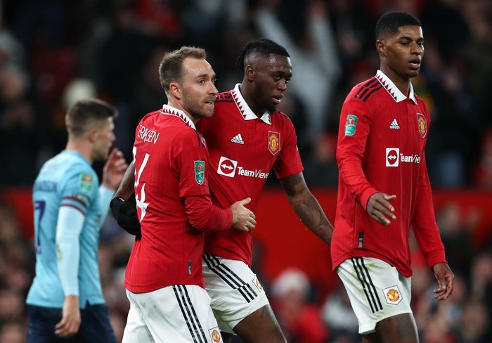 MANCHESTER, ENGLAND - DECEMBER 21: Christian Eriksen of Manchester United celebrates scoring their sides first goal with teammate Aaron Wan-Bissaka during the Carabao Cup Fourth Round match between Manchester United and Burnley at Old Trafford on December 21, 2022 in Manchester, England. (Photo by Lewis Storey/Getty Images)
