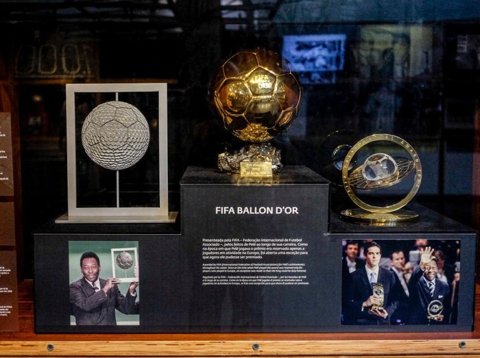 22 January 2022, Brazil, Santos: L-r: Player of the Century Trophy, received by Pelé in 2000. Golden Ball, award for Pelé in 2014. World Player Gala Trophy, a FIFA honor for Pelé in 2007 stand in a display case in the Pele Museum. Photo: Suamy Beydoun/dpa (Photo by Suamy Beydoun/picture alliance via Getty Images)