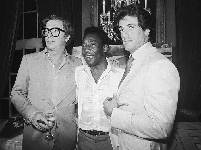 (L-R) Michael Caine, soccer great Pele, and Sylvester Stallone at a party celebrating the 7/16 opening of the film 