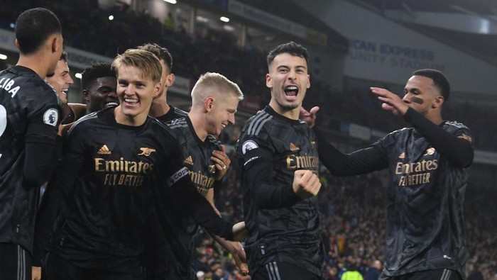 BRIGHTON, ENGLAND - DECEMBER 31: (L-R) Martin Odegaard and Gabriel Martinelli celebrate the 3rd Arsenal goal, scored by Eddie Nketiah during the Premier League match between Brighton & Hove Albion and Arsenal FC at American Express Community Stadium on December 31, 2022 in Brighton, England. (Photo by Stuart MacFarlane/Arsenal FC via Getty Images)