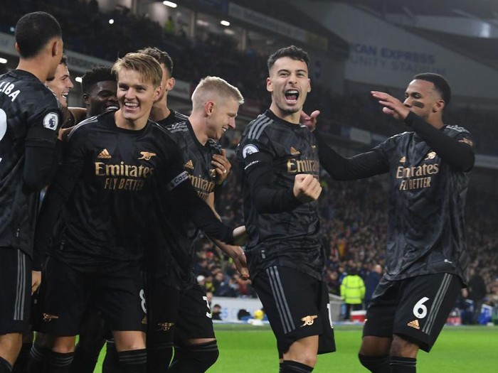 BRIGHTON, ENGLAND - DECEMBER 31: (L-R) Martin Odegaard and Gabriel Martinelli celebrate the 3rd Arsenal goal, scored by Eddie Nketiah during the Premier League match between Brighton & Hove Albion and Arsenal FC at American Express Community Stadium on December 31, 2022 in Brighton, England. (Photo by Stuart MacFarlane/Arsenal FC via Getty Images)