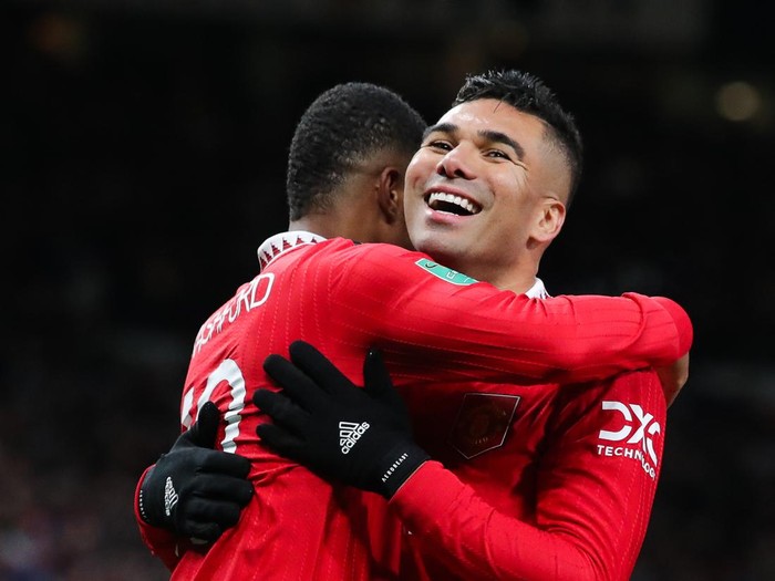 MANCHESTER, ENGLAND - DECEMBER 21: Marcus Rashford of Manchester United celebrates with Casemiro after scoring his sides second goal during the Carabao Cup Fourth Round match between Manchester United and Burnley at Old Trafford on December 21, 2022 in Manchester, England. (Photo by James Gill - Danehouse/Getty Images)