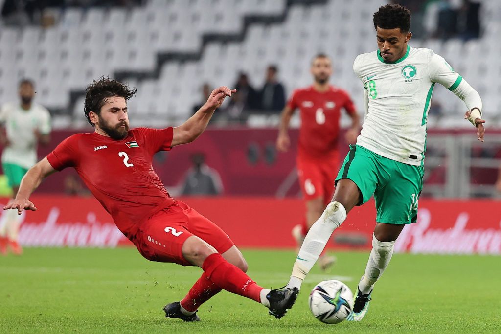 Palestine's defender Mohammed Khalil (L) and Saudi Arabia's midfielder Ayman Yahya vie for the ball during the FIFA Arab Cup 2021 group C football match between Palestine and Saudi Arabia at the Education City Stadium in the Qatari city of Ar-Rayyan on December 4, 2021. (Photo by KARIM JAAFAR / AFP) (Photo by KARIM JAAFAR/AFP via Getty Images)