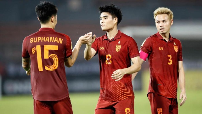 KUALA LUMPUR, MALAYSIA - 2022/12/20: Suphanan Bureerat (L), Peeradol Chamrasamee (C) Theerathon Bunmathan of Thailand celebrate after scoring a goal during the AFF Mitsubishi Electric Cup 2022 match between Thailand and Brunei at Kuala Lumpur Football Stadium Final score; Thailand 5:0 Brunei. (Photo by Wong Fok Loy/SOPA Images/LightRocket via Getty Images)