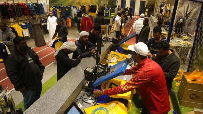 An employee prints out Cristiano Ronaldo jerseys at Al Nassr soccer club store in Riyadh, Saudi Arabia, Monday, Jan 2, 2023. Ronaldo completed a lucrative move to Saudi Arabian club Al Nassr on Friday in a deal that is a landmark moment for Middle Eastern soccer but will see one of Europe's biggest stars disappear from the sport's elite stage. (AP Photo/Amr Nabil)