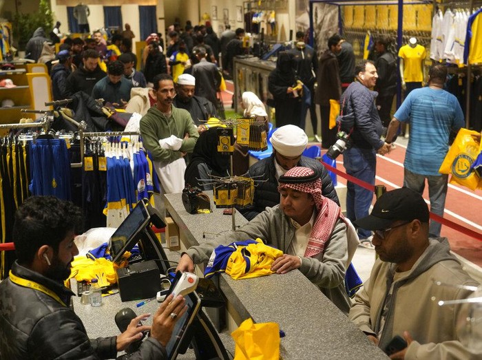 An employee prints out Cristiano Ronaldo jerseys at Al Nassr soccer club store in Riyadh, Saudi Arabia, Monday, Jan 2, 2023. Ronaldo completed a lucrative move to Saudi Arabian club Al Nassr on Friday in a deal that is a landmark moment for Middle Eastern soccer but will see one of Europe's biggest stars disappear from the sport's elite stage. (AP Photo/Amr Nabil)