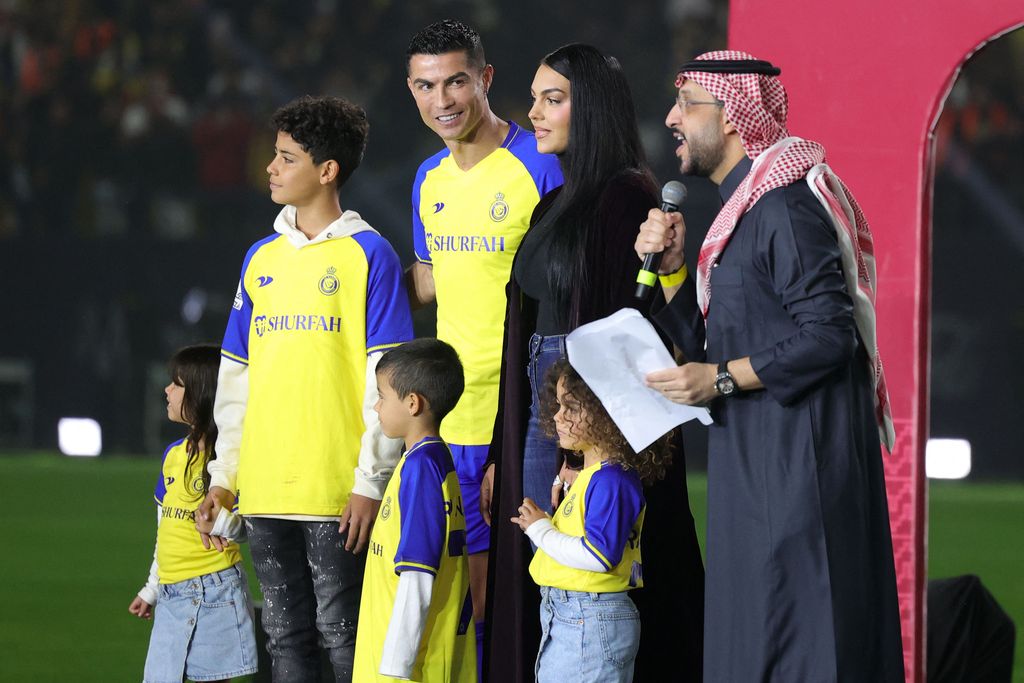 Al-Nassr's new Portuguese forward Cristiano Ronaldo (C-L), his partner Georgina Rodriguez (C-R) and his children stand on the stage during his unveiling at the Mrsool Park Stadium in the Saudi capital Riyadh on January 3, 2023. (Photo by Fayez Nureldine / AFP) (Photo by FAYEZ NURELDINE/AFP via Getty Images)