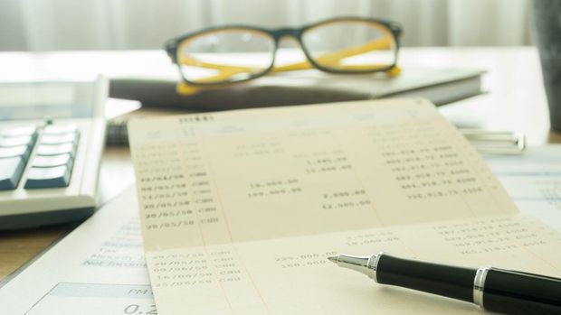 Accountants desk with pen and bank book. selective focus.