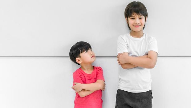 mother measuring height of her son