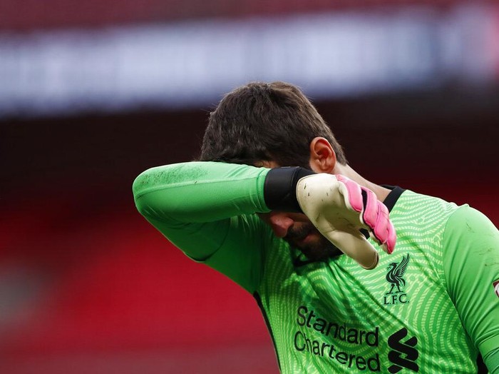 Liverpool goalkeeper Alisson Becker reacts during the penalty shootout during the English FA Community Shield soccer match between Arsenal and Liverpool at Wembley stadium in London, Saturday, Aug. 29, 2020. (Andrew Couldridge/Pool via AP)