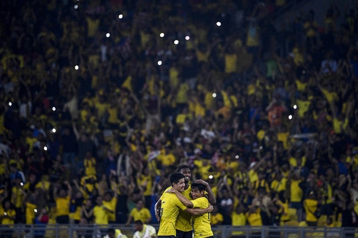Malaysias players celebrate after winning during the Qatar 2022 FIFA World Cup qualifying football match between Malaysia and Thailand at the Bukit Jalil Stadium in Bukit Jalil on November 14, 2019. (Photo by Mohd RASFAN / AFP)