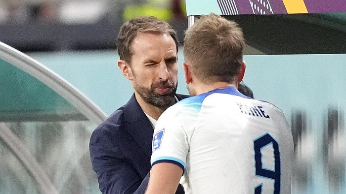 Englands head coach Gareth Southgate winks to Englands Harry Kane after he was changed out during the World Cup group B soccer match between England and Iran at the Khalifa International Stadium in in Doha, Qatar, Monday, Nov. 21, 2022. (AP Photo/Martin Meissner)