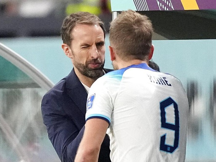 England's head coach Gareth Southgate winks to England's Harry Kane after he was changed out during the World Cup group B soccer match between England and Iran at the Khalifa International Stadium in in Doha, Qatar, Monday, Nov. 21, 2022. (AP Photo/Martin Meissner)
