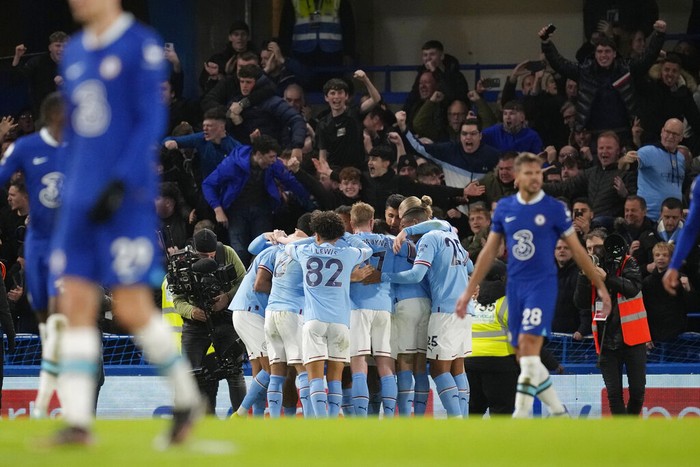 Manchester Citys team players celebrate after Riyad Mahrez scored the opening goal during the English Premier League soccer match between Chelsea and Manchester City at Stamford Bridge stadium in London Thursday, Jan. 5, 2023. (AP Photo/Kirsty Wigglesworth)