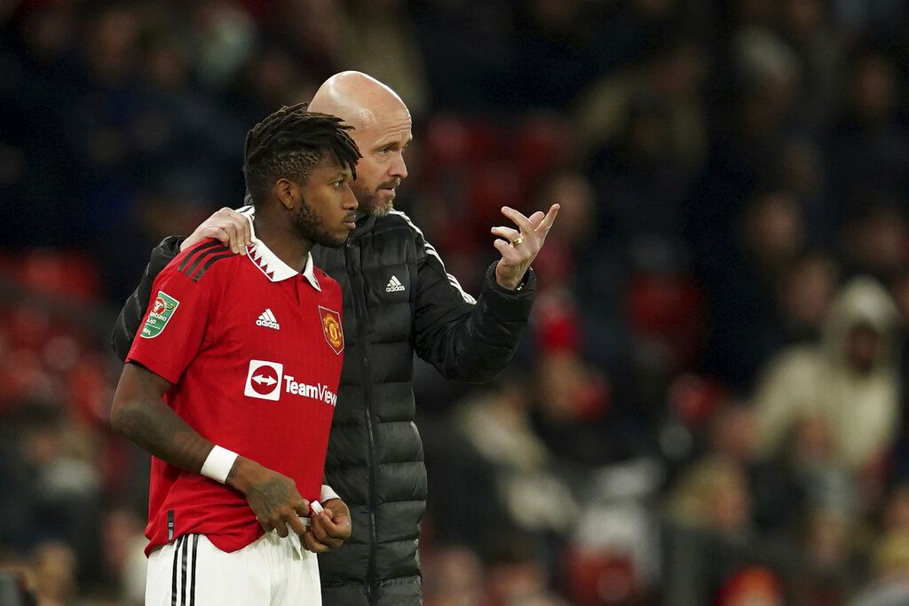 Manchester United's head coach Erik ten Hag, right gestures as he speaks to substitute Manchester United's Fred during the English League Cup 4th round soccer match between Manchester United and Burnley, at Old Trafford in Manchester, England Wednesday, Dec. 21, 2022. (AP Photo/Dave Thompson)