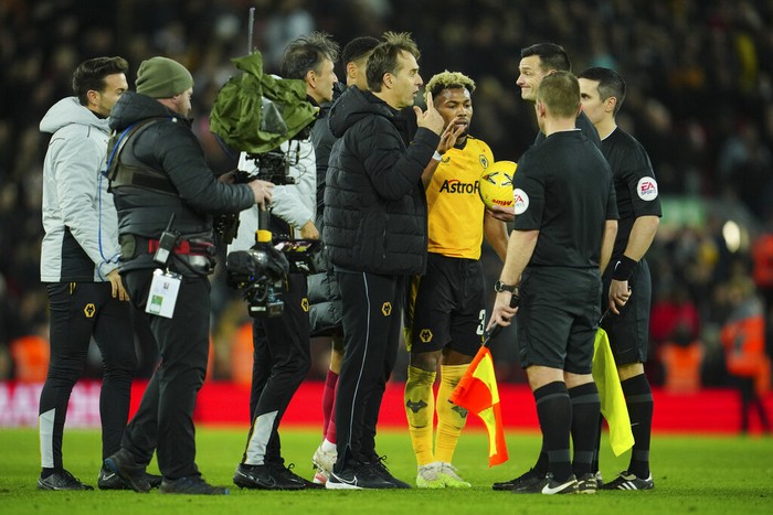 Wolverhampton Wanderers coach Julen Lopetegui, centre, speaks to referee Andy Madley after the English FA Cup soccer match between Liverpool and Wolverhampton Wanderers at Anfield in Liverpool, England Saturday, Jan. 7, 2023 (AP Photo/Jon Super)