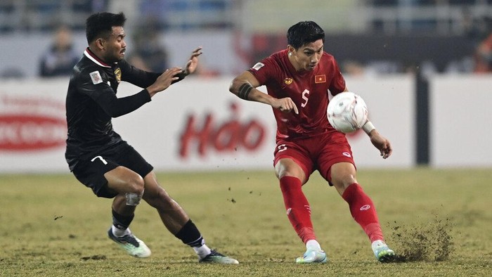 Vietnams Doan Van Hau, right, battles for the ball against Indonesias Saddle Ramdani during the ASEAN Football Federation (AFF) Mitsubishi Electric Cup 2022 semi-final match at My Dinh National Stadium in Hanoi, Vietnam, Monday, Jan. 9, 2023. (AP Photo/Nguyen Manh Quan)
