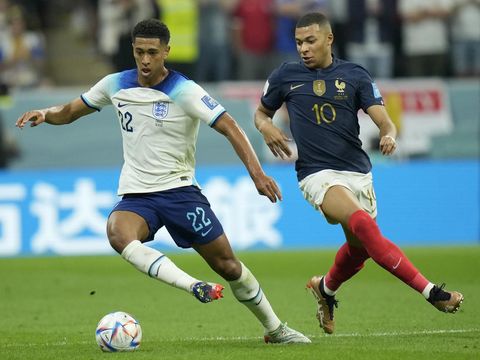 France's Kylian Mbappe vies for the ball with England's Jude Bellingham, left, during the World Cup quarterfinal soccer match between England and France, at the Al Bayt Stadium in Al Khor, Qatar, Saturday, Dec. 10, 2022. (AP Photo/Francisco Seco)