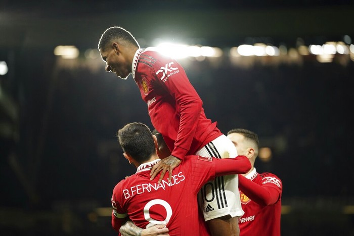 Manchester United players celebrate the opening goal of their team during the English FA Cup soccer match between Manchester United and Everton at Old Trafford in Manchester, England, Friday, Jan. 6, 2023. (AP Photo/Dave Thompson)