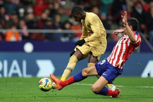 Atletico Madrid's Montenegrin defender Stefan Savic (R) tackles Barcelona's French forward Ousmane Dembele during the Spanish League football match between Club Atletico de Madrid and FC Barcelona at the Wanda Metropolitano stadium in Madrid on January 8, 2023. (Photo by Thomas COEX / AFP)