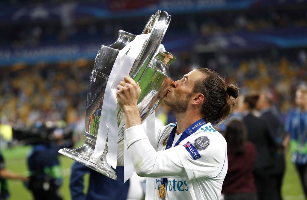 FILE -  Real Madrid's Gareth Bale celebrates with the trophy after winning the Champions League Final soccer match between Real Madrid and Liverpool at the Olimpiyskiy Stadium in Kiev, Ukraine, Saturday, May 26, 2018. (AP Photo/Pavel Golovkin, File)