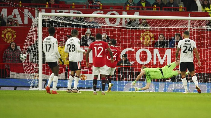 Charlton's goalkeeper Ashley Maynard-Brewer, second from right, misses the opening goal by Manchester United's Antony, not in the picture, during the English League Cup quarter final soccer match between Manchester United and Charlton Athletic at Old Trafford in Manchester, England, Tuesday, Jan. 10, 2023. (AP Photo/Dave Thompson)
