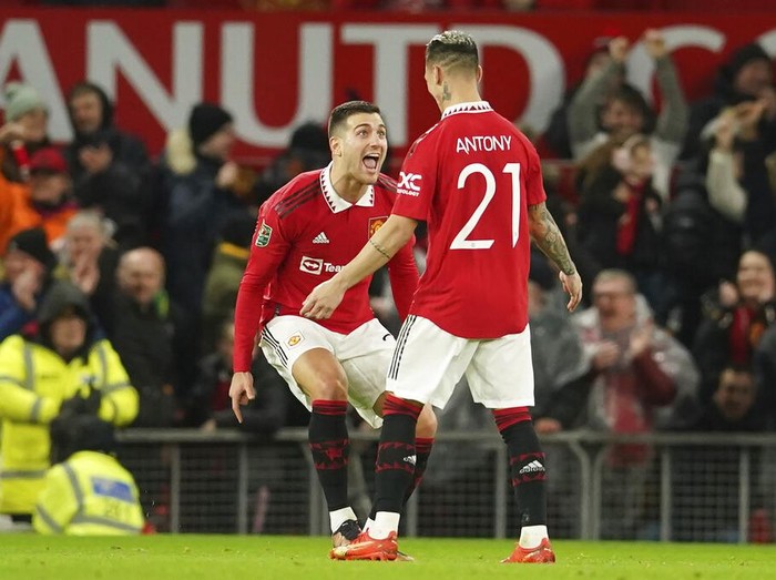 Manchester United's Antony, right, celebrates with Diogo Dalot after scoring the opening goal during the English League Cup quarter final soccer match between Manchester United and Charlton Athletic at Old Trafford in Manchester, England, Tuesday, Jan. 10, 2023. (AP Photo/Dave Thompson)