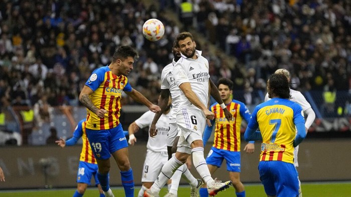 Valencias Hugo Duro, left, and Real Madrids Nacho jump for the ball during a semi-final of the Spanish Super Cup between Real Madrid and Valencia in Riyadh, Saudi Arabia, Wednesday, Jan. 11, 2023. (AP Photo/Hussein Malla)