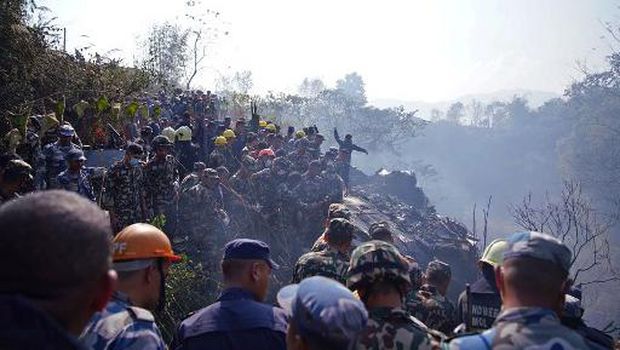 Rescuers inspect the site of a plane crash in Pokhara on January 15, 2023. - An aircraft with 72 people on board crashed in Nepal on January 15, Yeti Airlines and a local official said. (Photo by Yunish Gurung / AFP)