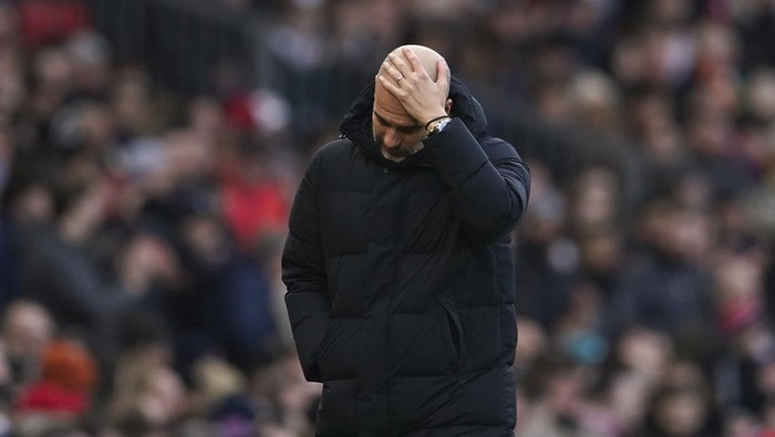 Manchester Citys head coach Pep Guardiola reacts during the English Premier League soccer match between Manchester United and Manchester City at Old Trafford in Manchester, England, Saturday, Jan. 14, 2023. (AP Photo/Dave Thompson)