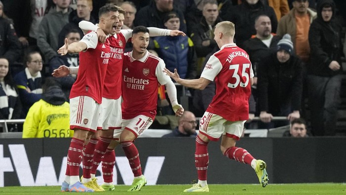 Arsenal players celebrate after Arsenals Martin Odegaard scored his sides second goal during the English Premier League soccer match between Tottenham Hotspur and Arsenal at the Tottenham Hotspur Stadium in London, England, Sunday, Jan. 15, 2023. (AP Photo/Frank Augstein)