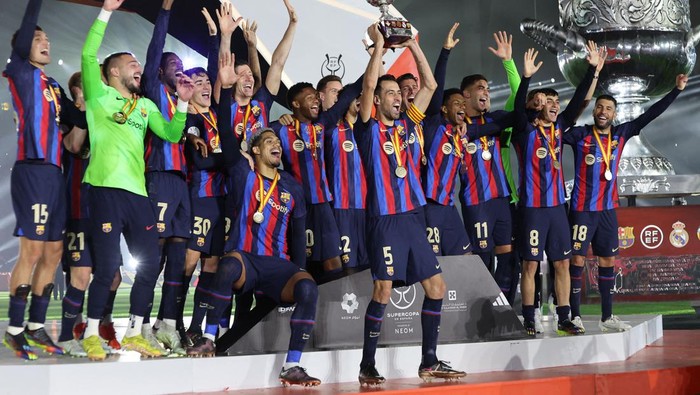 Barcelonas players celebrate on the podium after winning the Spanish Super Cup final football match between Real Madrid CF and FC Barcelona at the King Fahd International Stadium in Riyadh, Saudi Arabia, on January 15, 2023. (Photo by Giuseppe CACACE / AFP) (Photo by GIUSEPPE CACACE/AFP via Getty Images)