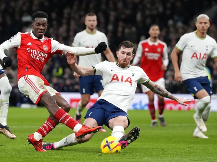 Brrr... Arsenal Kokoh di Puncak Klasemen Liga Inggris Tottenham's Pierre-Emile Hojbjerg, centre, challenges for the ball with Arsenal's Eddie Nketiah during the English Premier League soccer match between Tottenham Hotspur and Arsenal at the Tottenham Hotspur Stadium in London, England, Sunday, Jan. 15, 2023. (AP Photo/Frank Augstein)