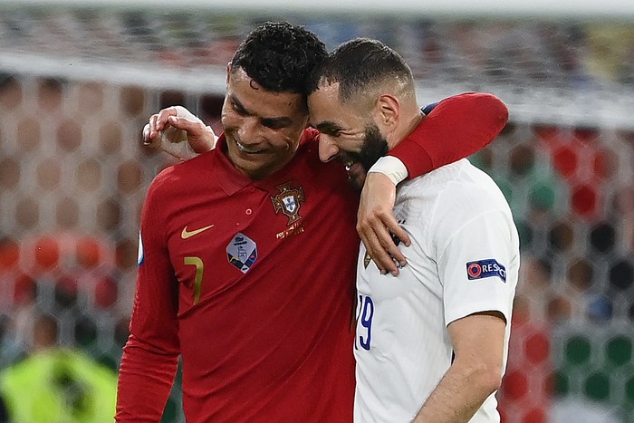 Portugals forward Cristiano Ronaldo and Frances forward Karim Benzema walk together off the pitch in half-time of the UEFA EURO 2020 Group F football match between Portugal and France at Puskas Arena in Budapest on June 23, 2021. (Photo by FRANCK FIFE / POOL / AFP) (Photo by FRANCK FIFE/POOL/AFP via Getty Images)