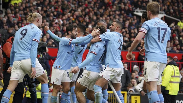 Manchester Citys Jack Grealish celebrates after scoring his sides first goal during the English Premier League soccer match between Manchester United and Manchester City at Old Trafford in Manchester, England, Saturday, Jan. 14, 2023. (AP Photo/Dave Thompson)