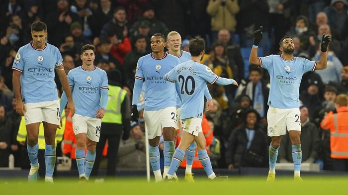 Manchester Citys Riyad Mahrez, right, celebrates after scoring his sides fourth goal during the English Premier League soccer match between Manchester City and Tottenham Hotspur at the Etihad Stadium in Manchester, England, Thursday, Jan. 19, 2023. (AP Photo/Dave Thompson)