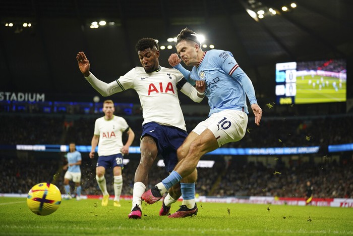 Manchester Citys Jack Grealish, right, attempts a shot at goal in front of Tottenhams Emerson Royal during the English Premier League soccer match between Manchester City and Tottenham Hotspur at the Etihad Stadium in Manchester, England, Thursday, Jan. 19, 2023. (AP Photo/Dave Thompson)