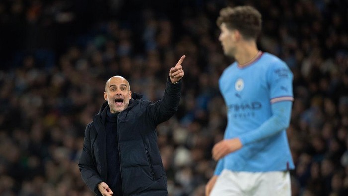 MANCHESTER, ENGLAND - JANUARY 19: Manchester City manager Pep Guardiola shouts instructions to John Stones during the Premier League match between Manchester City and Tottenham Hotspur at Etihad Stadium on January 19, 2023 in Manchester, United Kingdom. (Photo by Visionhaus/Getty Images)