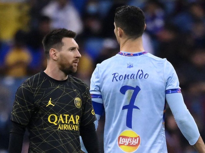 TOPSHOT - Paris Saint-Germain's Argentine forward Lionel Messi (L) walks past Riyadh All-Star's Portuguese forward Cristiano Ronaldo (R) during the Riyadh Season Cup football match between the Riyadh All-Stars and Paris Saint-Germain at the King Fahd Stadium in Riyadh on January 19, 2023. (Photo by FRANCK FIFE / AFP) (Photo by FRANCK FIFE/AFP via Getty Images)