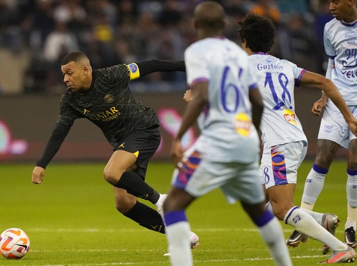 PSG's Kylian Mbappe controls the ball playing against a combined XI of Saudi Arabian teams Al Nassr and Al Hilal during a friendly soccer match, at the King Saud University Stadium, in Riyadh, Saudi Arabia, Thursday, Jan. 19, 2023. (AP Photo/Hussein Malla)