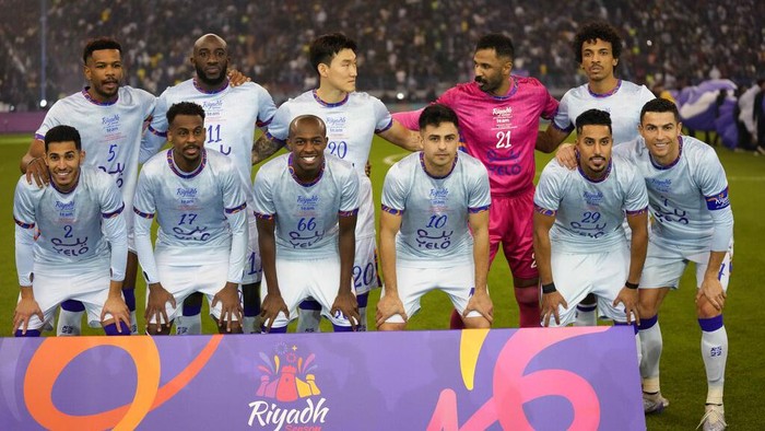 Cristiano Ronaldo, right, poses with a combined XI of Saudi Arabian teams Al Nassr and Al Hilal prior to the start of a friendly soccer match against PSG, at the King Saud University Stadium, in Riyadh, Saudi Arabia, Thursday, Jan. 19, 2023. (AP Photo/Hussein Malla)