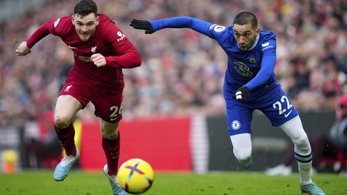 Liverpools Andrew Robertson challenges for the ball with Chelseas Hakim Ziyech during the English Premier League soccer match between Liverpool and Chelsea at Anfield stadium in Liverpool, England, Saturday, Jan. 21, 2023. (AP Photo/Jon Super)