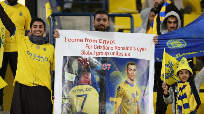 Cristiano Ronaldo, Al Nassr vs Al Ettifaq Soccer Football - Saudi Pro League - Al Nassr v Al Ettifaq - Mrsool Park, Riyadh, Saudi Arabia - January 22, 2023 A fan poses with a sign in reference to Al Nassr's Cristiano Ronaldo inside the stadium before the match REUTERS/Ahmed Yosri