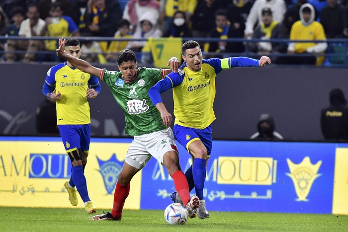 Al Nassrs Cristiano Ronaldo, right, fights for the ball during the Saudi Pro League match between Al Ettifaq FC and Al Nassr FC at Mrsool Park Stadium, in Riyadh, Saudi Arabia, Sunday, Jan. 22, 2023. (AP Photo)