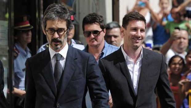 Barcelona football star Lionel Messi (R), his brother Rodrigo and lawyer Cristobal Martell (L) leave the courhouse in the coastal town of Gava near Barcelona on September 27, 2013 after an audience on tax evasion charges.  Messi and his father are accused of trying to deceive the Spanish taxman to the tune of four million euros ($5 million, 3.4 million) by ceding the player's image rights to companies based in tax havens such as Belize and Uruguay.  AFP PHOTO / JOSEP LAGO (Photo by JOSEP LAGO / AFP)