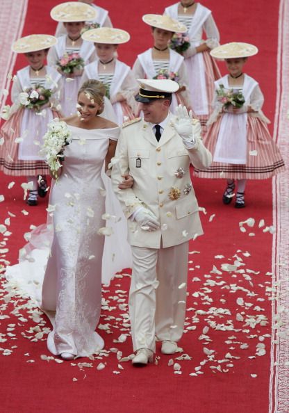 MONACO - JULY 02:  Princess Charlene of Monaco and Prince Albert Of Monaco smile as they leave the palace after the religious ceremony of the Royal Wedding of Prince Albert II of Monaco to Charlene Wittstock in the main courtyard at Prince's Palace on July 2, 2011 in Monaco, Monaco. The Roman-Catholic ceremony follows the civil wedding which was held in the Throne Room of the Prince's Palace of Monaco on July 1. With her marriage to the head of state of the Principality of Monaco, Charlene Wittstock will become Princess consort of Monaco and gain the title, Princess Charlene of Monaco. Celebrations including concerts and firework displays are being held across several days, attended by a guest list of global celebrities and heads of state.  (Photo by Andreas Rentz/Getty Images)