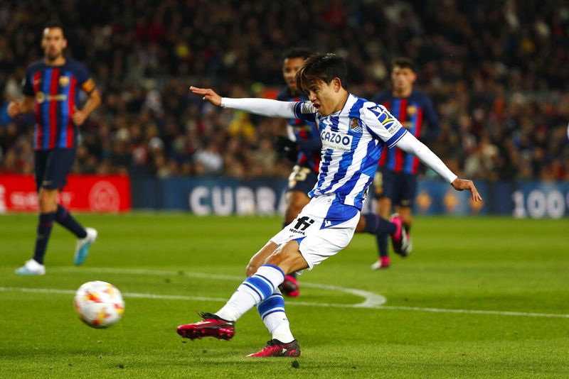 Real Sociedad's Takefusa Kubo kicks the ball during the Spanish Copa del Rey soccer match between Barcelona and Real Sociedad at the Camp Nou stadium, in Barcelona, Spain, Wednesday, Jan. 25, 2023. (AP Photo/Joan Monfort)