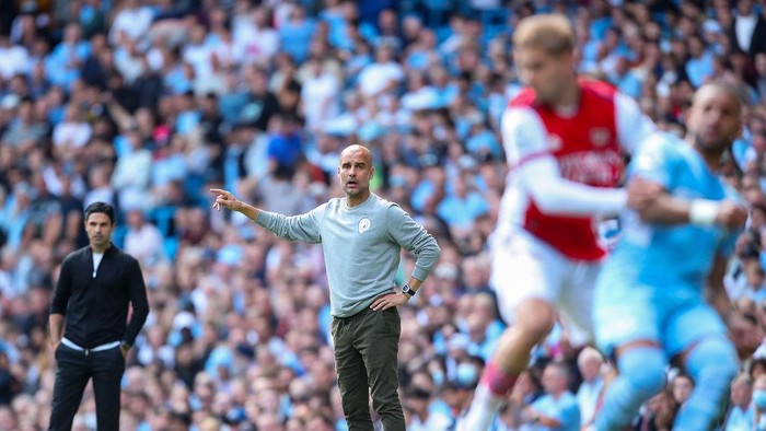 MANCHESTER, ENGLAND - AUGUST 28: Pep Guardiola the head coach / manager of Manchester City looks on during the Premier League match between Manchester City  and  Arsenal at Etihad Stadium on August 28, 2021 in Manchester, England. (Photo by Robbie Jay Barratt - AMA/Getty Images)