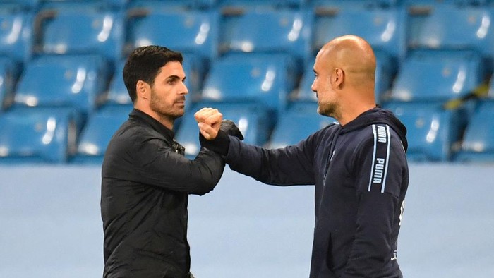 Pep Guardiola-Mikel Arteta Arsenals Spanish head coach Mikel Arteta (L) bumps arms with Manchester Citys Spanish manager Pep Guardiola (R) at the end of the match during the English Premier League football match between Manchester City and Arsenal at the Etihad Stadium in Manchester, north west England, on June 17, 2020. - The Premier League makes its eagerly anticipated return today after 100 days in lockdown but behind closed doors due to coronavirus restrictions. (Photo by PETER POWELL / POOL / AFP) / RESTRICTED TO EDITORIAL USE. No use with unauthorized audio, video, data, fixture lists, club/league logos or live services. Online in-match use limited to 120 images. An additional 40 images may be used in extra time. No video emulation. Social media in-match use limited to 120 images. An additional 40 images may be used in extra time. No use in betting publications, games or single club/league/player publications. / (Photo by PETER POWELL/POOL/AFP via Getty Images)
